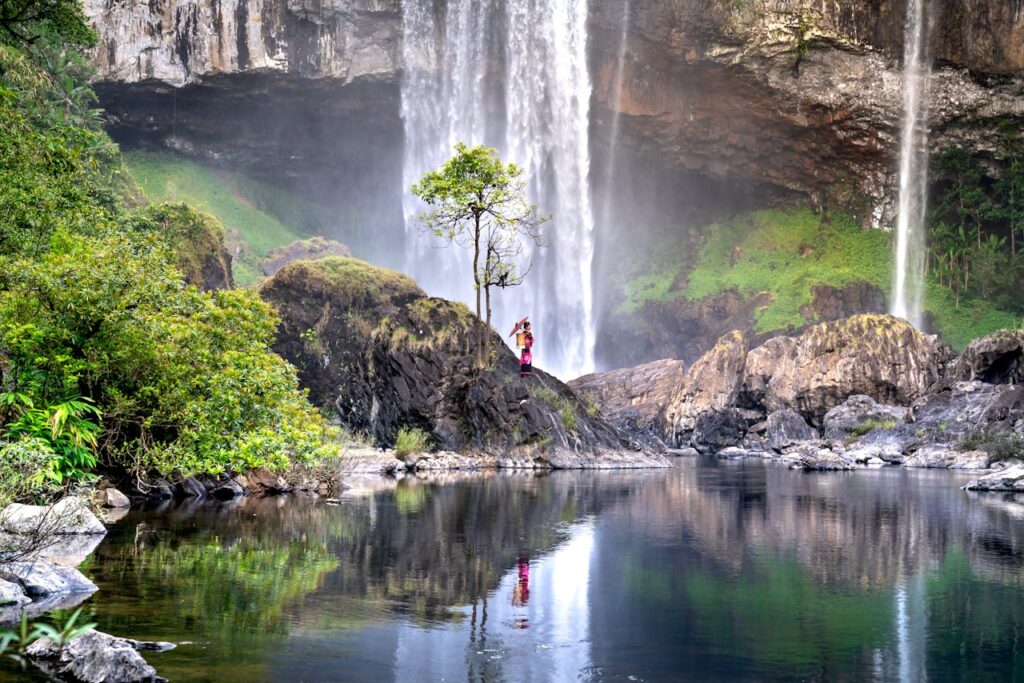 pexels-photo-10615691 Photographer captures serene waterfall and pool in verdant Vietnamese landscape.